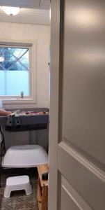 a room with a bunk bed and a window at Hostel Cafe Huvila in Oulu