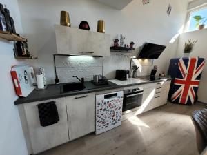 a kitchen with a sink and a stove top oven at L'Appart Indus et Parking Privé in Blois