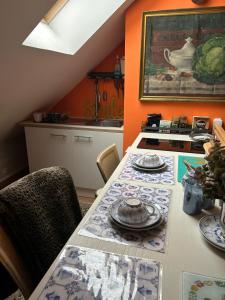 a kitchen with a table with plates on it at Villa grain de sel in Étaples +16 photos