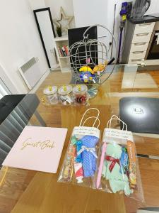 a table with some toys and a paper on it at City Center Balcony by the Universities in Manchester