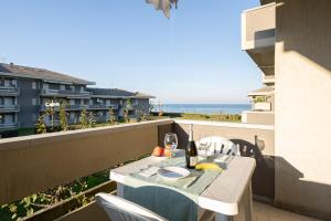 a table on a balcony with a view of the ocean at Green Marine in Silvi Marina