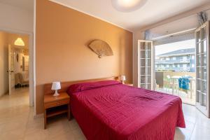 a bedroom with a bed with a red bedspread at Green Marine in Silvi Marina