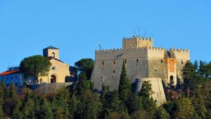 坎波巴索Dimora Paradiso的山顶上有一座城堡，树丛茂密