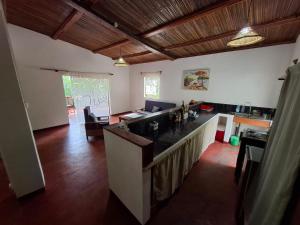 a living room with a kitchen with a counter top at Villa des îles Nosy Komba in Nosy Komba
