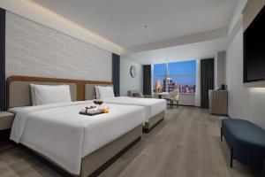 Postel nebo postele na pokoji v ubytování Huanman Hotel Luoyang Yingtianmen Jiefang Road Metro Station Branch