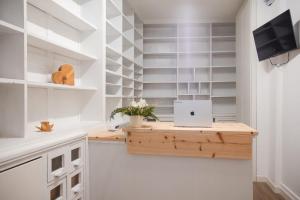 a desk in a kitchen with a laptop on it at Garni Pola in Campocologno