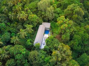 an aerial view of a house in the middle of a forest at EKOSTAY Gold - AshBee Villa in Kīhīm