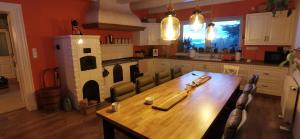 a kitchen with a wooden table and a fireplace at Komfortowy Dom w Chmurach in Dydnia