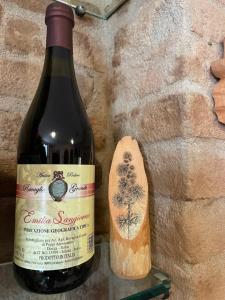 a bottle of wine sitting next to a cork at Agriturismo Ravaglia Grande in Castel Guelfo di Bologna