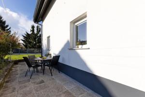 a patio with a table and chairs and a window at Apartments Lia in Ljubljana