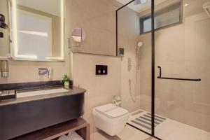 a bathroom with a shower and a toilet and a sink at Hotel Urban chant in Rishīkesh