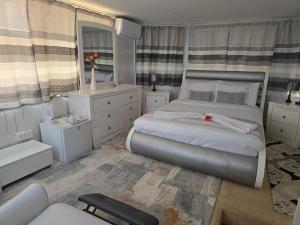 Apelles Palace Guest House - executive room 2 في Tlokweng: غرفة نوم بها سرير كبير ومرآة