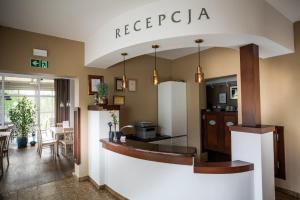 a lobby with a reception area with a refrigerator at Hotel Słoneczne Tarasy in Grybów
