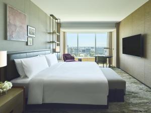 a hotel room with a large bed and a television at InterContinental Sapporo by IHG in Sapporo