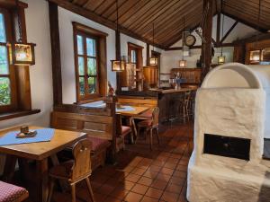 a restaurant with tables and chairs and a counter at FerienFleckl in Warmensteinach