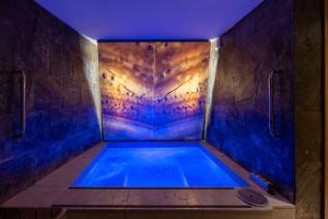 a hot tub with a blue lighting in a room at Tulip City Hotel & SPA in Istanbul