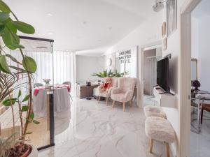 a living room with a dog sitting in a chair at nakyro suite in Pomigliano dʼArco