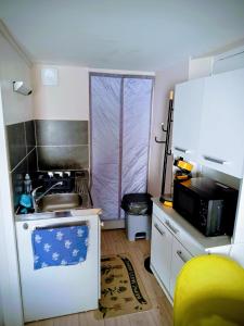 a small kitchen with a sink and a microwave at Studio cosy, tout équipé, WI-FI proche Clinique Saint-Pierre in Perpignan