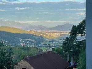 a view of a city with mountains in the distance at Aanshi homestay in Nagarkot