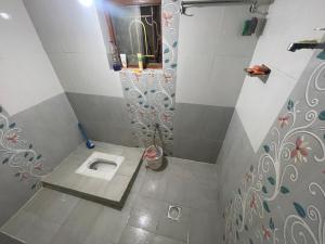 a bathroom with a shower with a toilet in it at Aanshi homestay in Nagarkot