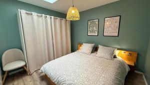 a bedroom with a white bed and a chair at Le Gingko in Montmerle Sur Saône +10 photos