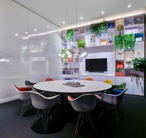 a dining room with a white table and chairs at citizenM Miami World Center in Miami