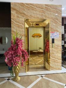 a lobby with two vases of flowers and an umbrella at Square Hostel in Ha Long