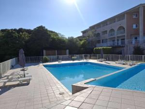 ein Schwimmbad vor einem Gebäude in der Unterkunft Studio ensoleillé à Saint-Florent avec piscine in Saint-Florent