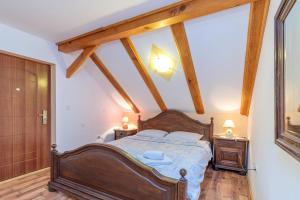 a bedroom with a bed and two night stands at Pool & Wellness Twin Chalets Zavrh in Šimatovo