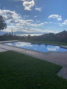 a small pool of water on a brick walkway at Casa Vacacional O PIÑEIRO in Piñeiro