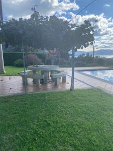 a picnic table in a park next to a pool at Casa Vacacional O PIÑEIRO in Piñeiro
