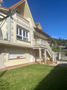 a large house with a lawn in front of it at Casa Vacacional O PIÑEIRO in Piñeiro +47 photos