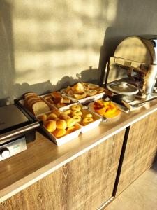 a buffet with different types of bread and pastries at Kuri Hotel in Padre Bernardo