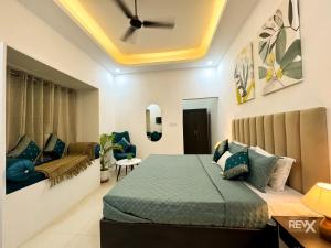 a bedroom with a bed and a couch at Wanna Ayodhya in Ayodhya