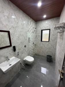 a bathroom with a sink and a toilet at Nirvana Bhimashankar Jungle Resort in Bhimashankar +38 photos