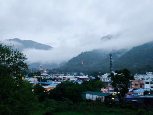 a view of a city with mountains in the background at Hotel Shree Hari in Rishīkesh