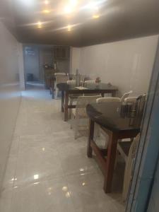 a row of tables and chairs in a restaurant at Astha Resturent pragti bhavan in Lucknow
