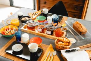 a table with a breakfast of food and drinks at Bread et Couette in Lyon