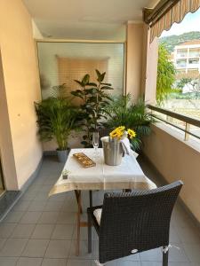 a table and chairs on a balcony with plants at Studio grande terrasse 2 min plage & commerces in Roquebrune-Cap-Martin