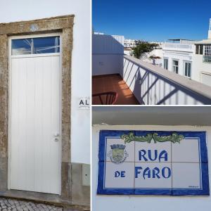 a white door and a sign on a building at Villa Graça Olhão in Olhão