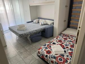 a small room with a bed and a table at Studio grande terrasse 2 min plage & commerces in Roquebrune-Cap-Martin