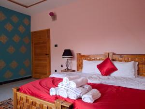 a bedroom with a bed with towels on it at Sultan Resorts 7 star Luxurious accommodations 