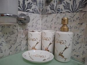 a bathroom counter with a bottle of soap and a plate at Sultan Resorts 7 star Luxurious accommodations 