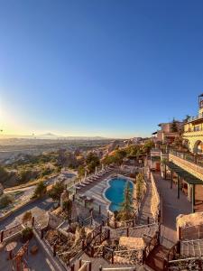 an aerial view of a resort with a pool at CCR Cappadocia Cave Resort &Spa in Eskiömerler