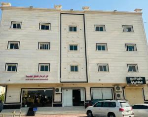 a white car parked in front of a building at تاج 2 in Al Kharj