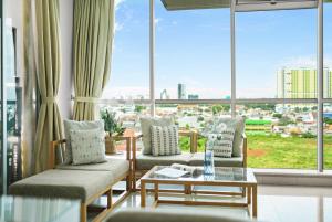a living room with windows and a view of a city at Lily by Kozystay - Kuningan in Jakarta
