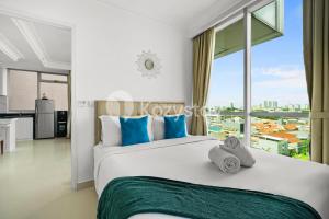 a bedroom with a large bed and a large window at Lily by Kozystay - Kuningan in Jakarta +23 photos