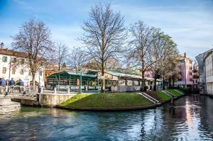a boat in a river next to a city at Ca' Molinetto in Treviso