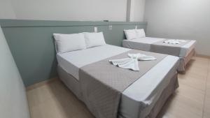 Postel nebo postele na pokoji v ubytování Urupês Hotel