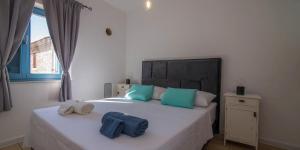 a bedroom with a bed with two towels on it at Pinea in Veli Lošinj